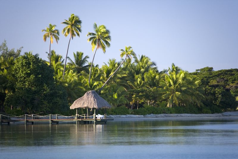 Overwater bungalows on a turquoise South Pacific lagoon